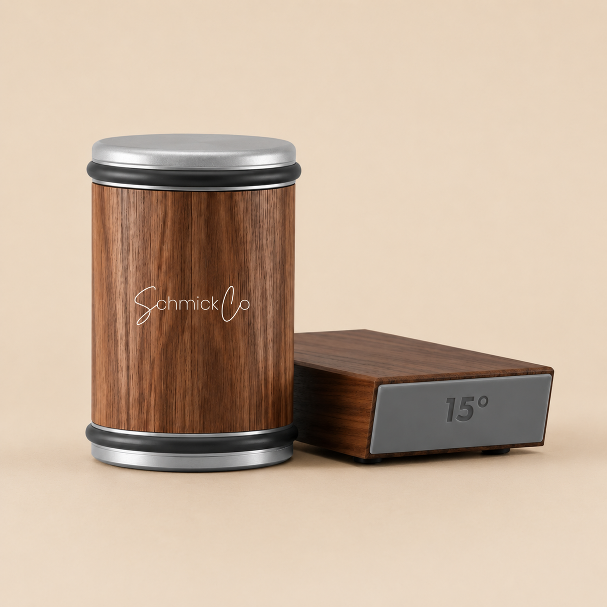 A wooden canister with a silver metal lid and base, featuring the 'SchmickCo' logo, stands next to a matching wooden box with a gray digital temperature display showing 15°C, set against a solid beige background.