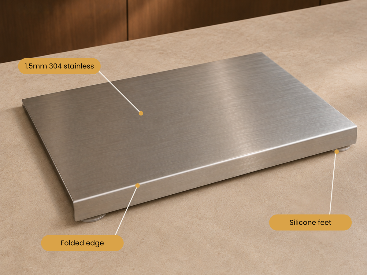 A brushed stainless steel platform scale with labeled callouts showing a 1.5mm 304 stainless top, folded edge, and silicone feet, photographed on a beige countertop.